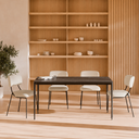 Comedor moderno con mesa negra, sillas tapizadas y estantería de madera de MB Mobles