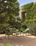 Sillón Net Relax en agave con cojín giungla, sofá Net Bench y mesa Net 100, en un jardín – Nardi